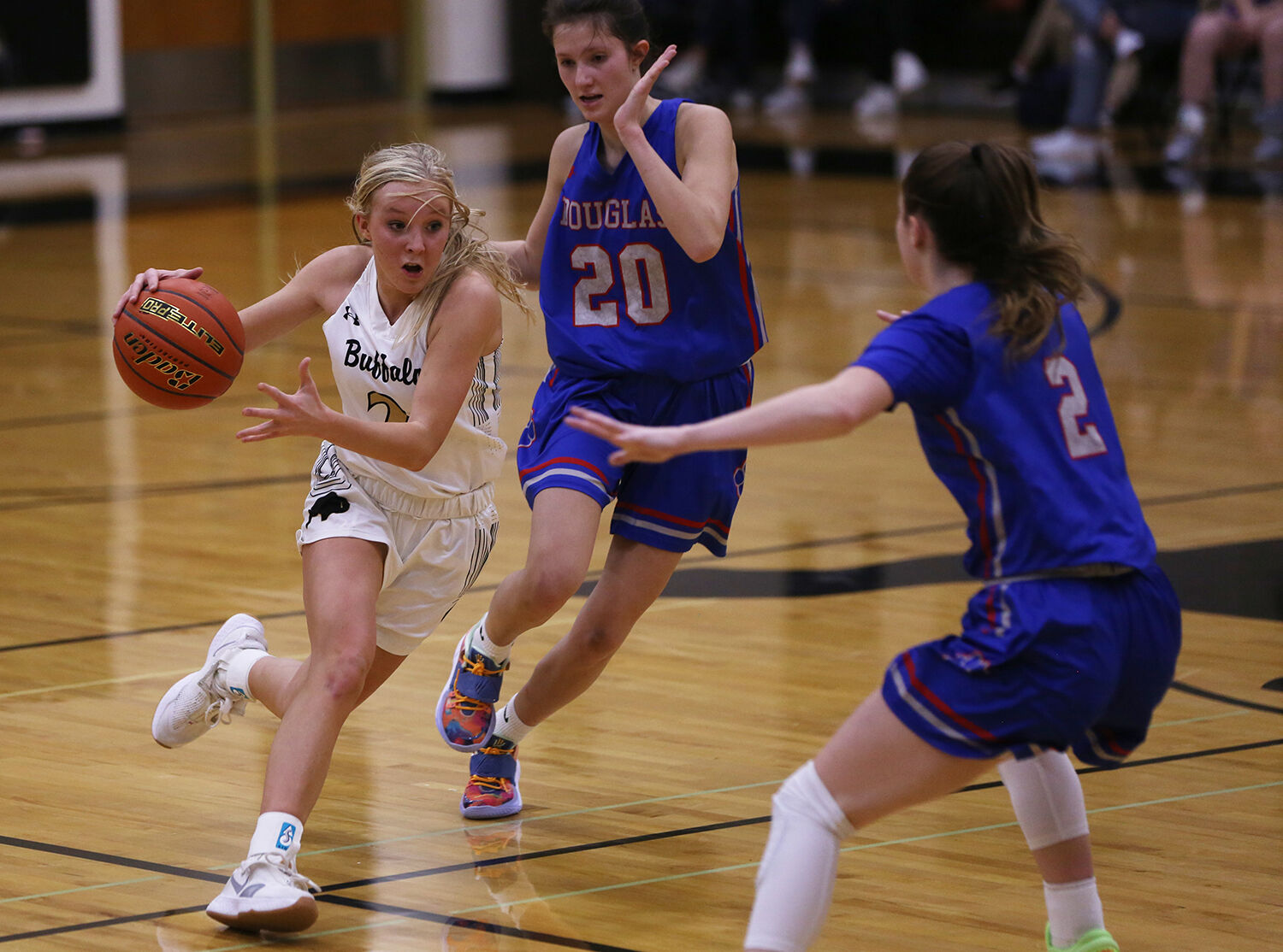 Kendall Tietjen dribbles down court through Douglas defenders Kamdynn Townsend